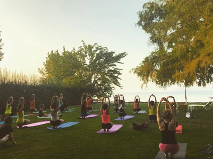 Yoga group lesson outdoors with a view on Lake Garda 25